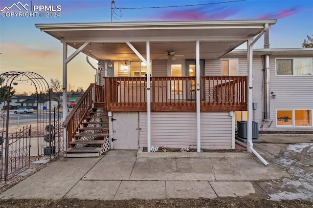 back house at dusk featuring a porch, central AC, and ceiling fan