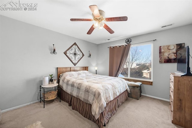 bedroom with light carpet and ceiling fan