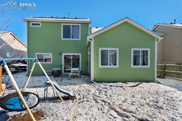 rear view of house with a playground