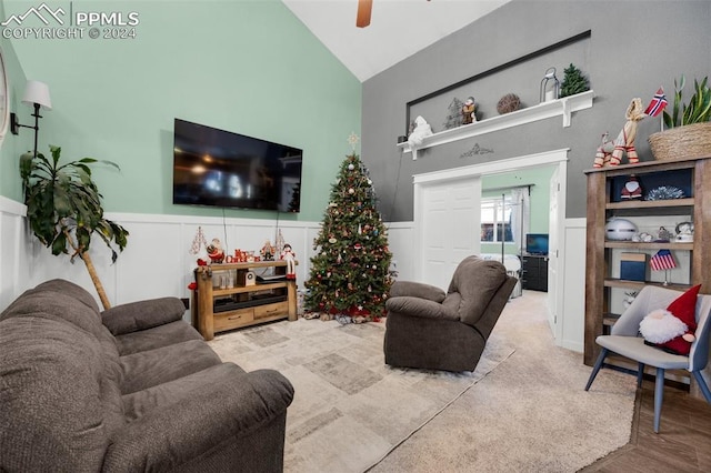 living room featuring ceiling fan and vaulted ceiling