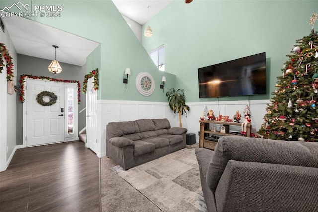 living room with hardwood / wood-style flooring and vaulted ceiling