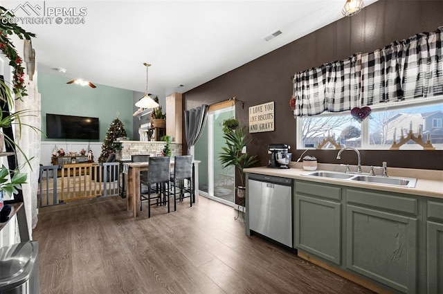 kitchen featuring dark hardwood / wood-style flooring, decorative light fixtures, stainless steel dishwasher, and sink