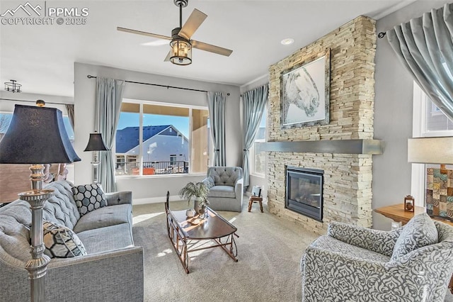 living room with a fireplace, carpet flooring, and ceiling fan