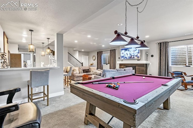 recreation room featuring light colored carpet, a textured ceiling, and pool table