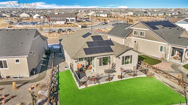 rear view of property with solar panels