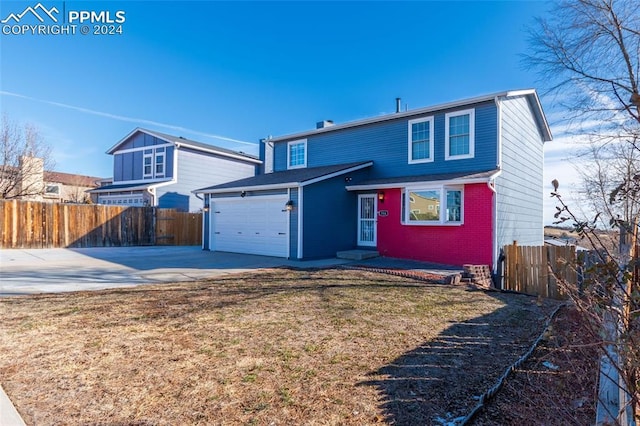 view of front of home with a garage and a front lawn