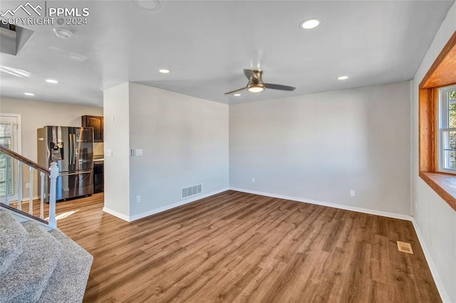 spare room featuring ceiling fan and light hardwood / wood-style flooring