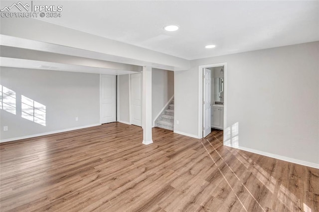 basement with hardwood / wood-style floors