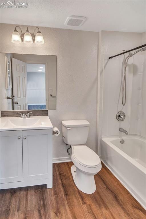 full bathroom featuring vanity, shower / bathing tub combination, wood-type flooring, and toilet