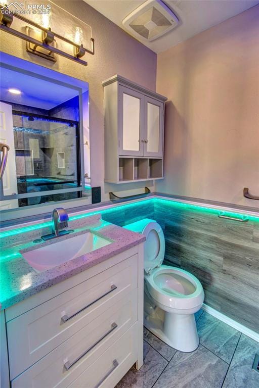 bathroom with tile patterned floors, vanity, and toilet