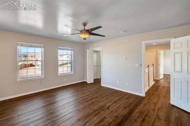 unfurnished bedroom with ceiling fan and dark hardwood / wood-style floors