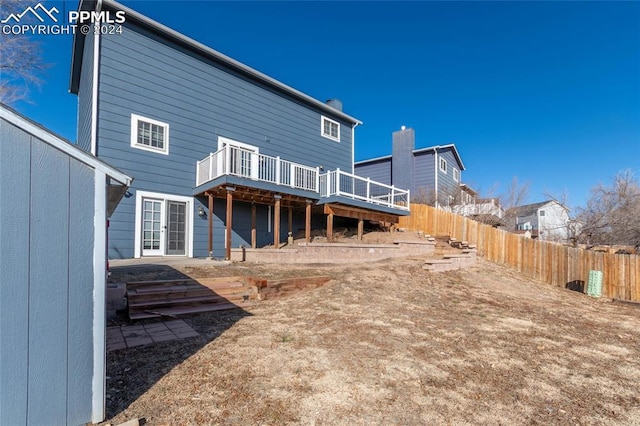 back of house featuring a deck