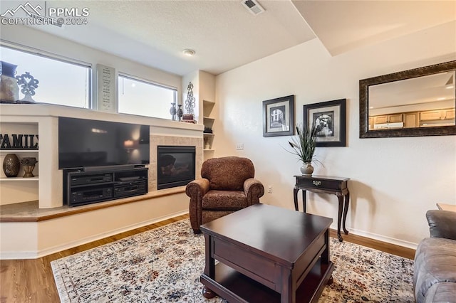 living room featuring hardwood / wood-style floors and a fireplace