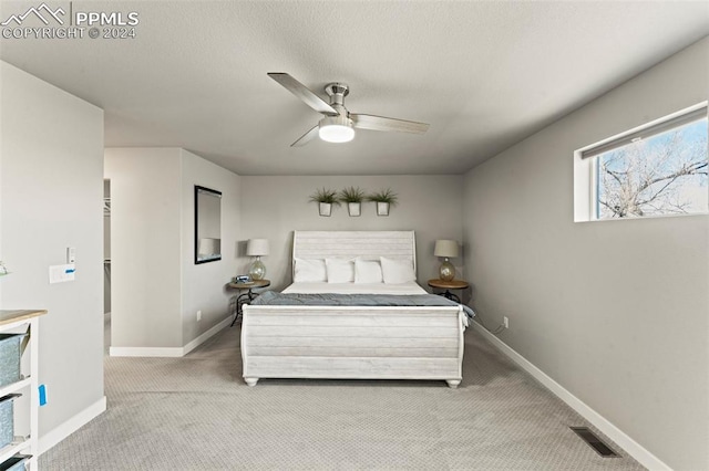 bedroom featuring light colored carpet and ceiling fan