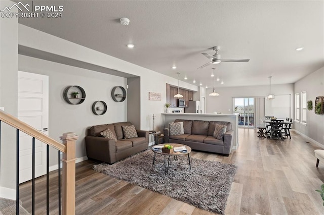 living room with hardwood / wood-style floors and ceiling fan