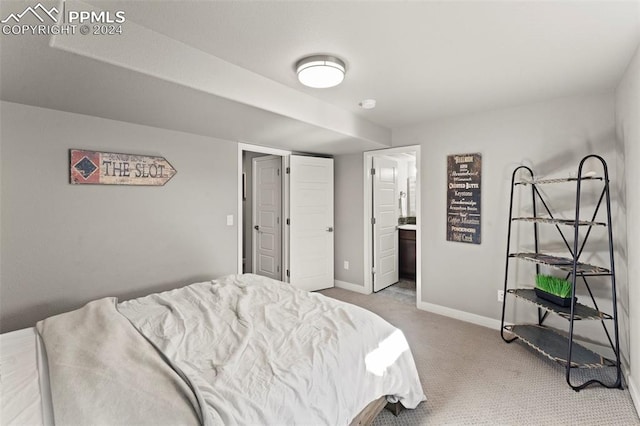 carpeted bedroom featuring ensuite bathroom