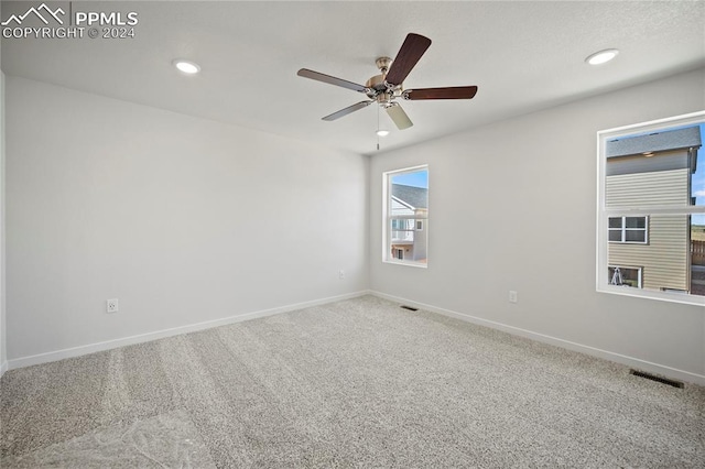 carpeted empty room featuring ceiling fan