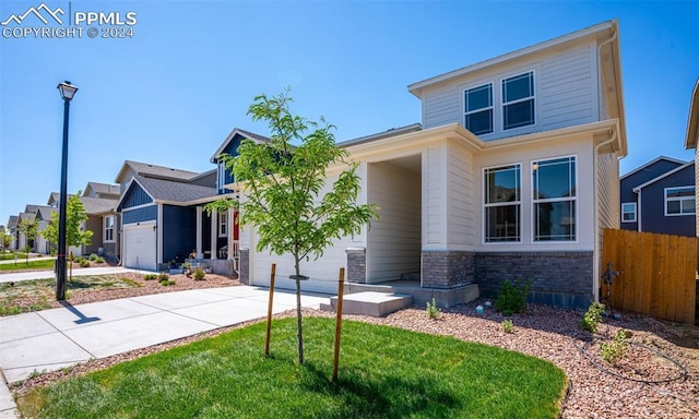 view of front of property with a front lawn and a garage