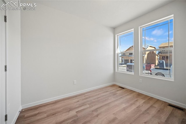 spare room with light hardwood / wood-style flooring