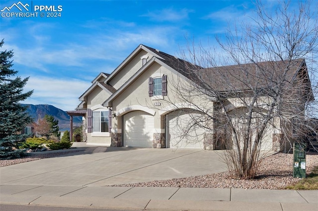 view of front of home with a mountain view and a garage