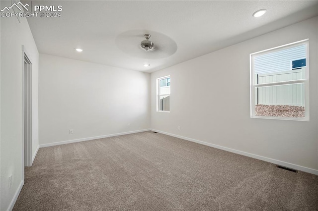 carpeted empty room with ceiling fan