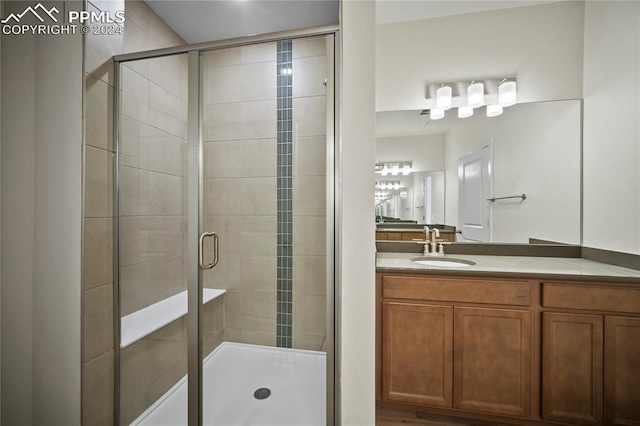 bathroom featuring walk in shower and vanity