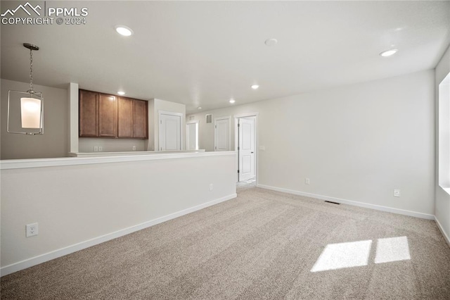 unfurnished room with light carpet