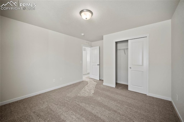 unfurnished bedroom featuring carpet floors and a closet