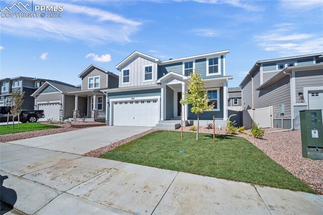 view of front of property featuring a front yard and a garage