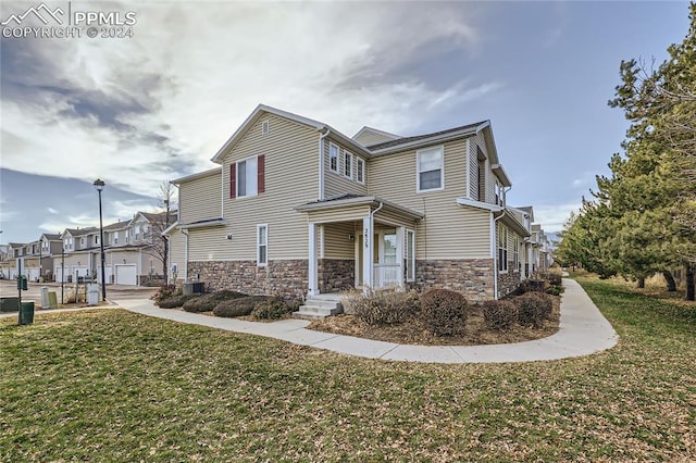 view of front of house featuring a front yard and central AC unit