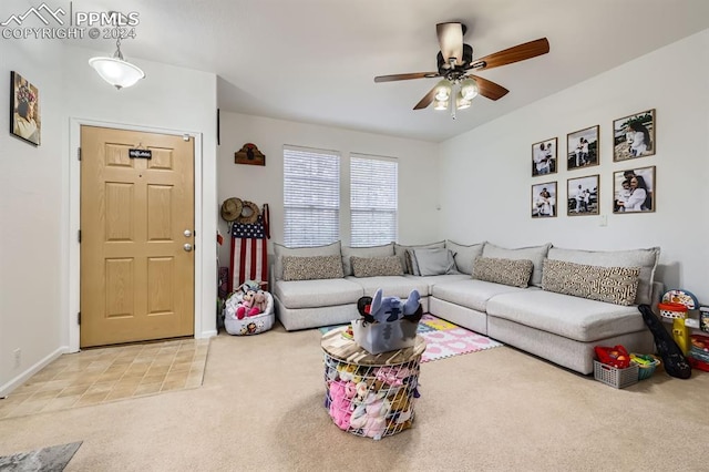 carpeted living room with ceiling fan