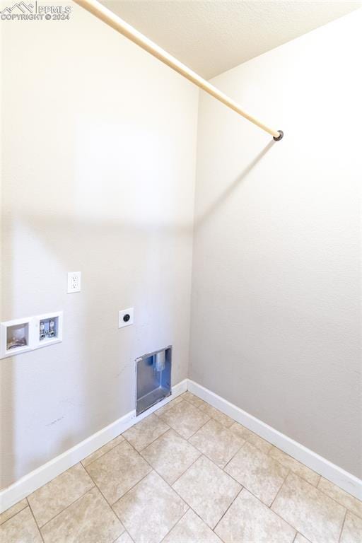 laundry room featuring hookup for an electric dryer, light tile patterned floors, and hookup for a washing machine