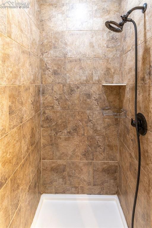 bathroom with tiled shower