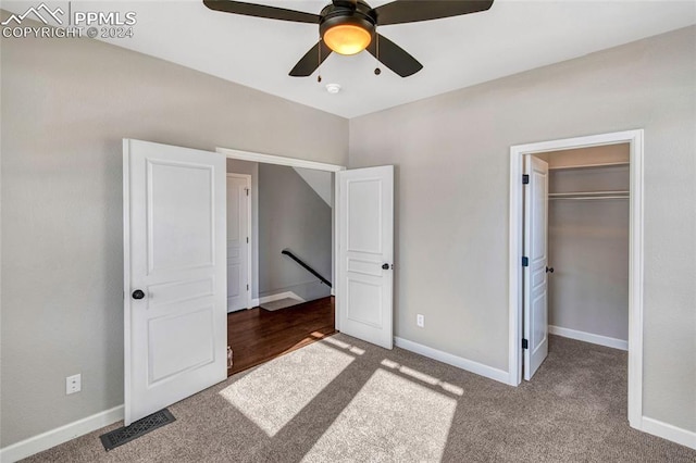 unfurnished bedroom featuring ceiling fan, a closet, carpet floors, and a spacious closet