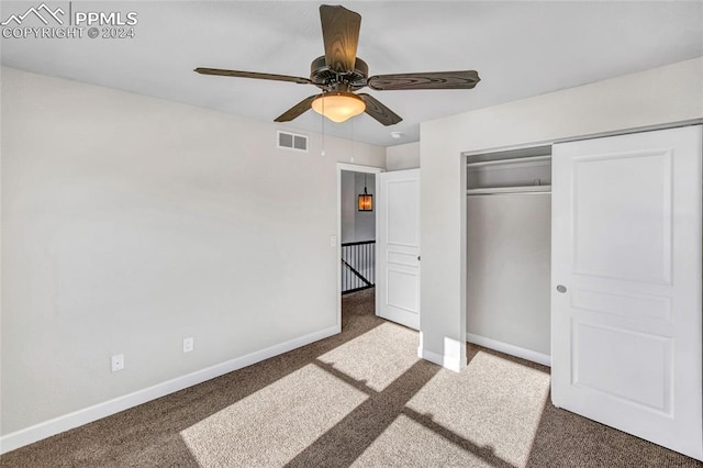 unfurnished bedroom featuring carpet flooring, a closet, and ceiling fan