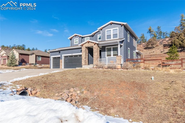 craftsman-style home with a porch and a garage