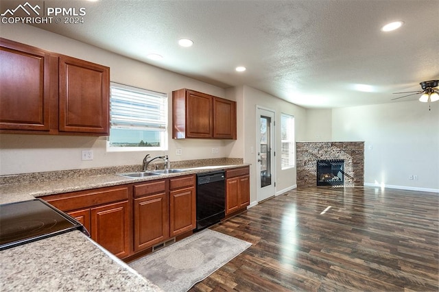 kitchen with a textured ceiling, ceiling fan, dark wood-type flooring, sink, and dishwasher