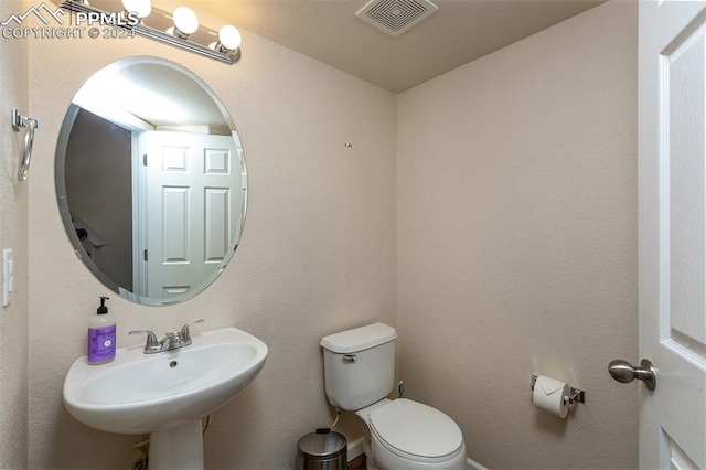 bathroom with sink and toilet