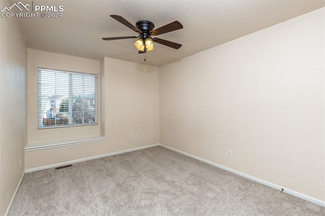 empty room with light colored carpet and ceiling fan