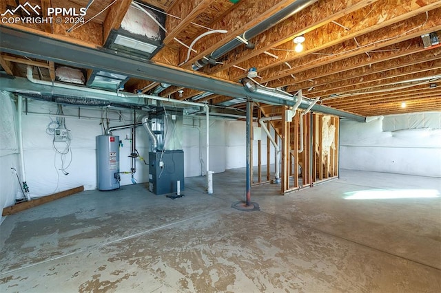 basement featuring heating unit and water heater