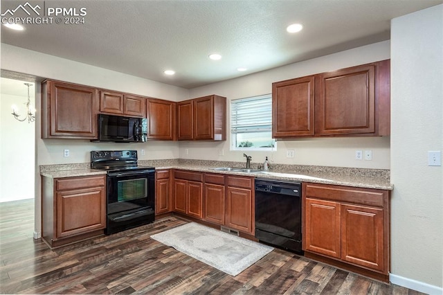 kitchen with a chandelier, sink, dark hardwood / wood-style floors, and black appliances