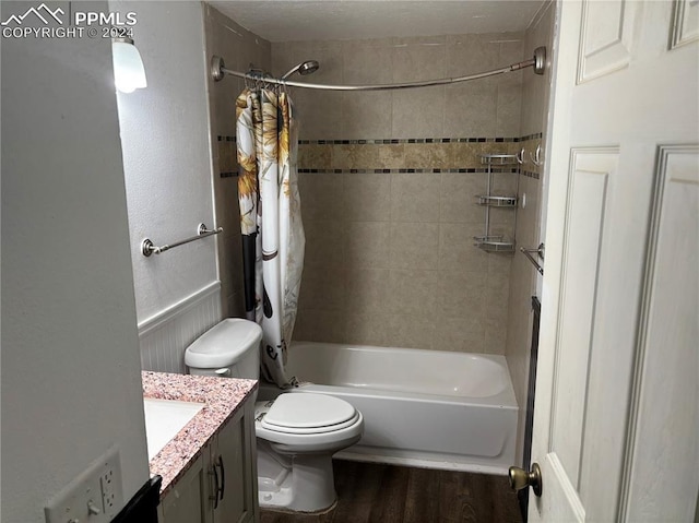 full bathroom with shower / bathtub combination with curtain, hardwood / wood-style flooring, vanity, and toilet