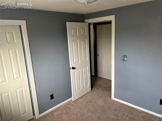 unfurnished bedroom with light carpet