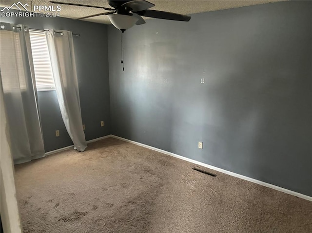 spare room with ceiling fan, carpet floors, and a textured ceiling