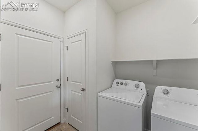 laundry room with washing machine and clothes dryer