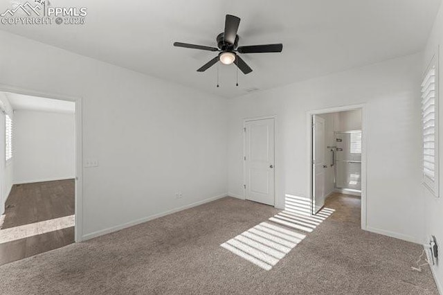 unfurnished bedroom featuring ceiling fan, ensuite bathroom, and carpet flooring