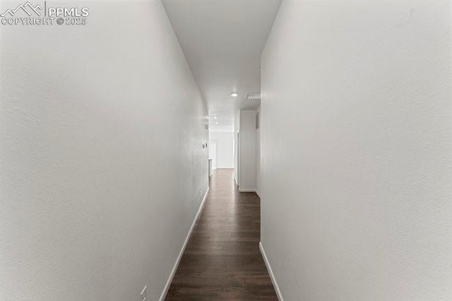 corridor featuring dark wood-type flooring