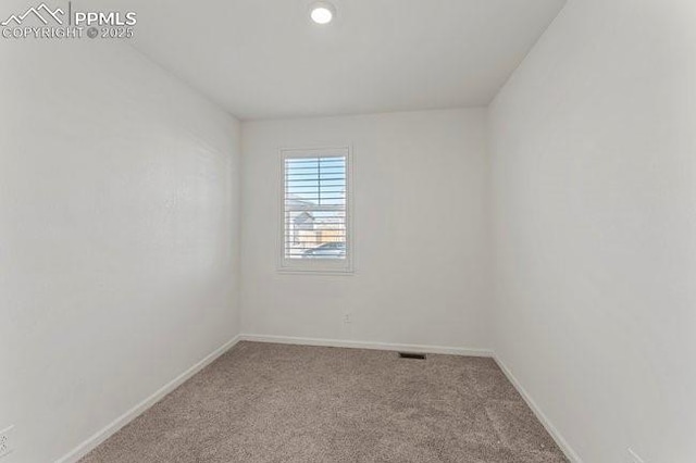 unfurnished room featuring light colored carpet