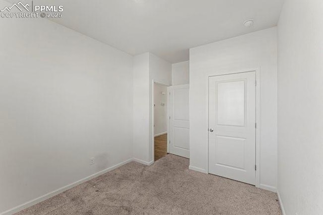 unfurnished bedroom featuring light colored carpet