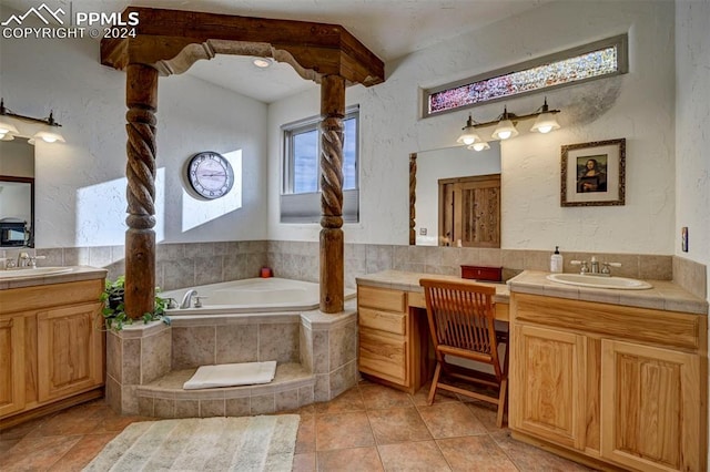 bathroom featuring vanity, tiled bath, and tile patterned floors